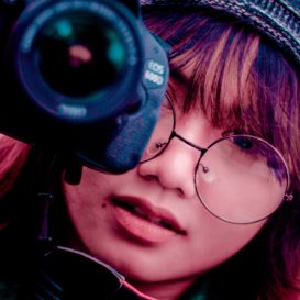 girl holding camera