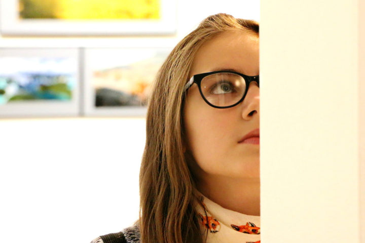 curator arranging art pieces on a gallery wall