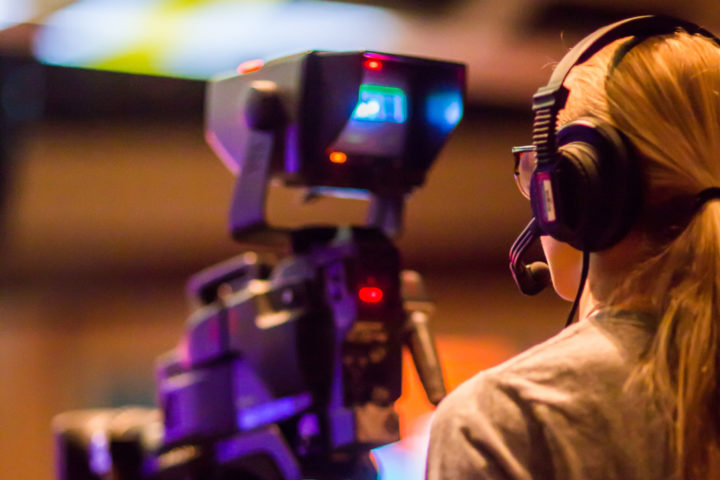 female camers operator filming in a studio