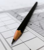pencil sits atop architectural plans