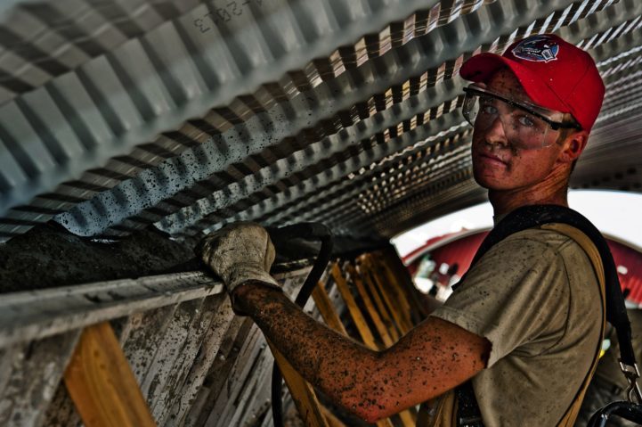 Mechanical Engineering Technologist working while wearing hat and safety goggles
