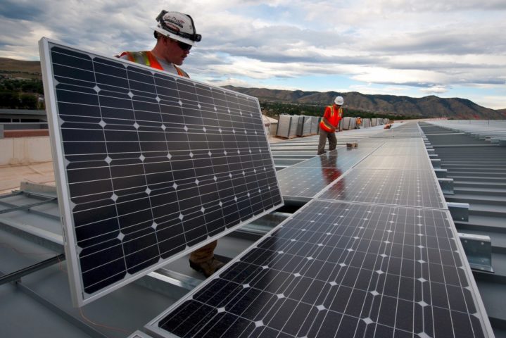 solar energy installation managers working on solar panels