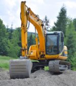 construction vehicle stands ready to dig at a construction site