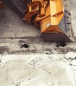 backhoe alongside new pavement