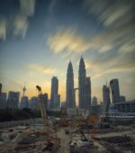 construction site in the foreground with a beautiful city skyline in the background