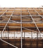 looking from the ground up on scaffolding surrouding a building under construction