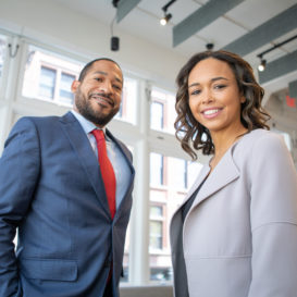 two business colleagues dressed in sharp suits in an office building