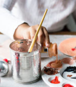 teacher pours paint into palette for childrens art project
