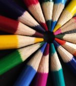 sharpened colored pencils arranged in a bright circle
