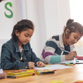 three third graders doing class work at their desks