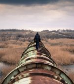 rusting pipeline interrupting the natural marsh setting