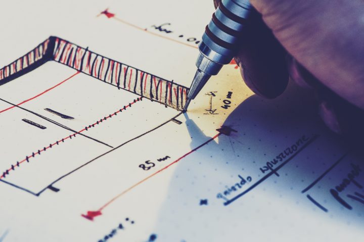 Architectural Drafter holding pen to paper while sketching
