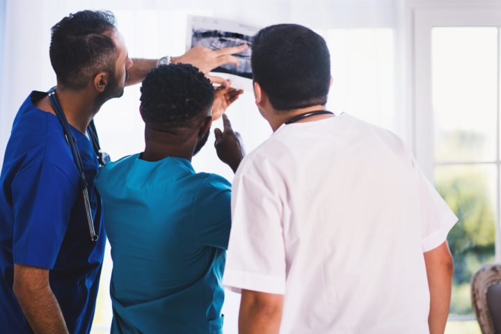 Radiologic Technology Assistants look at x-ray with radiologist