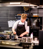 chef prepares meal in a high end kitchen