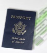 passport and ticket on a white counter