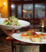 server carries two plates of food