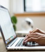 hands typing on a laptop