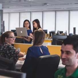 modern office with many desks and workers