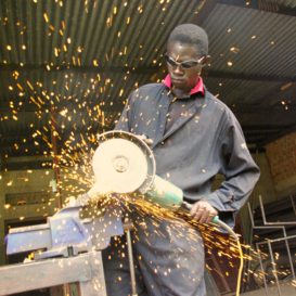 worker holding angle grinder
