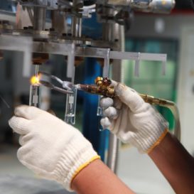welder wearing protective eye gear does electrical welding