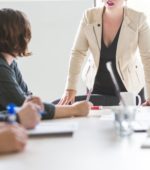 marketing manager runs meeting at conference table