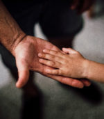 officer gives high five to young child