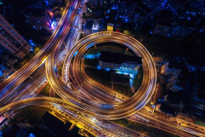 slow motion blurred lights of cars passing on a busy freeway at night